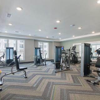 A spacious gym with various exercise machines and equipment for workouts.