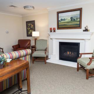 A cozy living room with a fireplace and comfortable seating arrangements.