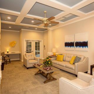A cozy living room with elegant decor, featuring comfortable seating and stylish artwork.