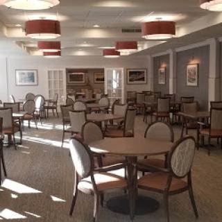 A spacious and elegantly designed dining area featuring tables and chairs arranged for patrons.
