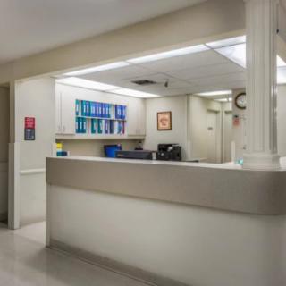 Hospital reception area with a nurses station and medical equipment.