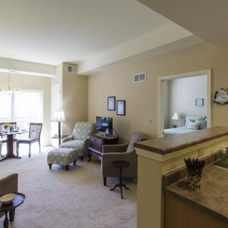 A cozy living room with a dining area, displaying comfortable furniture and ample natural light.