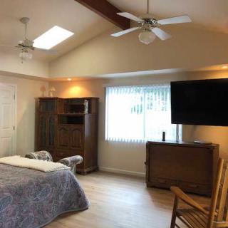 Spacious bedroom with modern amenities and natural light.