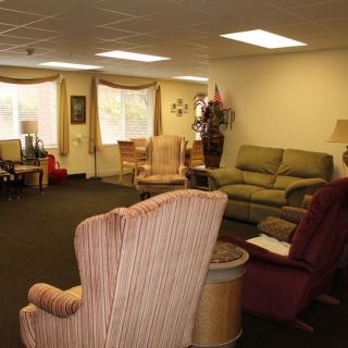 A cozy living room with sofas and chairs arranged for comfort.