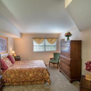 A cozy bedroom with classic furniture and soft lighting.