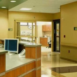 A hospital reception area with a desk and hallway.