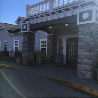 A welcoming hotel entrance featuring a combination of stone and wooden architectural elements.