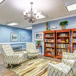 A cozy library seating area with armchairs and bookshelves.