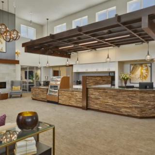 A modern lobby with wood accents and stylish lighting fixtures.