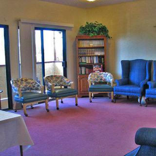 A cozy living room with comfortable seating and a bookshelf.