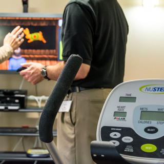 A fitness setup featuring a treadmill and a digital monitor, highlighting health monitoring technology.