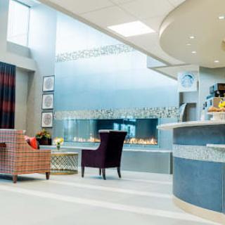 A modern and stylish lobby area featuring comfortable seating and a reception desk.