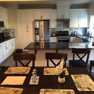 A modern kitchen with a sleek design, featuring an inviting dining area.