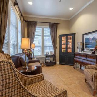 A cozy living room with stylish furniture and warm lighting.