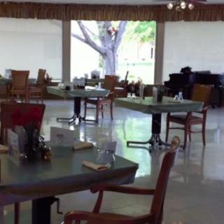 An empty dining area with neatly arranged tables and chairs.