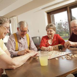 A group of seniors enjoying a game night together, sharing laughter and good times.