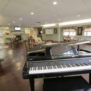 A cozy lounge area featuring a grand piano, perfect for music lovers.