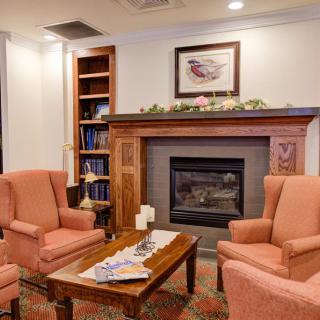 Cozy living room with armchairs and a fireplace.