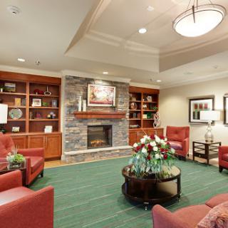 A cozy living room featuring comfortable seating and a warm fireplace.