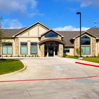 A modern commercial building with a welcoming entrance and well-maintained landscaping.