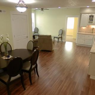Open concept living and dining area with hardwood floors and modern furnishings.