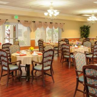 An elegantly arranged dining room with neatly set tables and comfortable chairs.