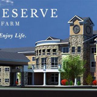 A luxurious residential building with a stone facade and clock tower, surrounded by trees.