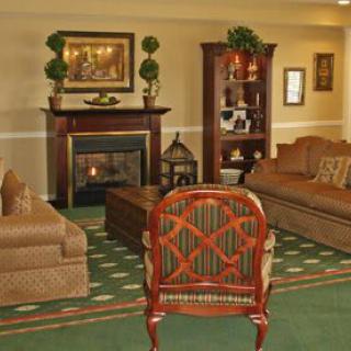 A cozy living room with elegant furniture and a warm fireplace.