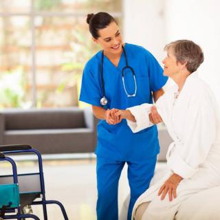 A nurse assisting an elderly patient in a healthcare setting.