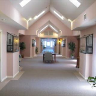 A spacious hallway with angled ceilings and soft lighting.