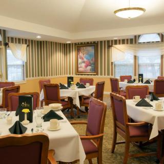 An elegant dining room with neatly arranged tables and chairs.