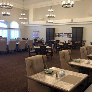 An elegant dining room with neatly arranged tables and comfortable seating.