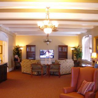 A cozy living room area featuring comfortable seating, a TV, and decorative elements.