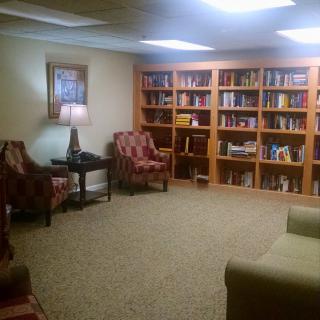 A cozy reading room with bookshelves and comfortable seating.