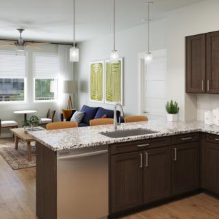 A modern open floor plan kitchen and living room with stylish furnishings and pendant lighting.
