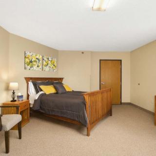 A cozy bedroom with a wooden bed, nightstands, and minimalist decor.