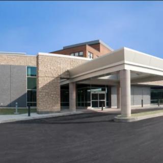 A modern hospital building with a prominent entrance.