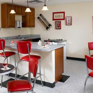 A retro-style kitchen with red diner chairs and vintage decor.