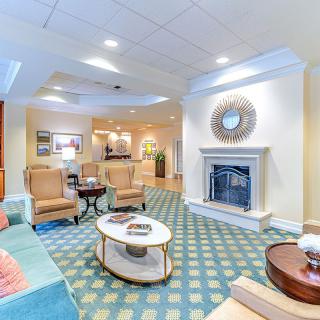 A cozy lounge area featuring comfortable seating and a stylish fireplace.