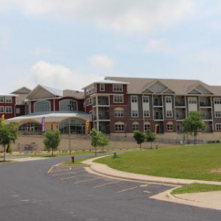 A modern residential apartment complex with landscaped surroundings.