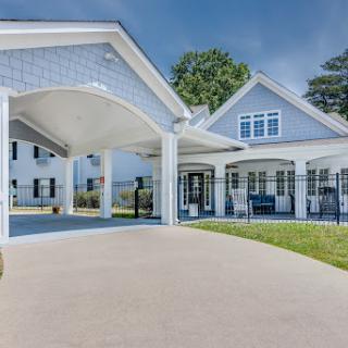 A contemporary home showcasing elegant architectural design with a spacious driveway.