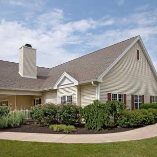 A well-maintained suburban house with a landscaped front yard.
