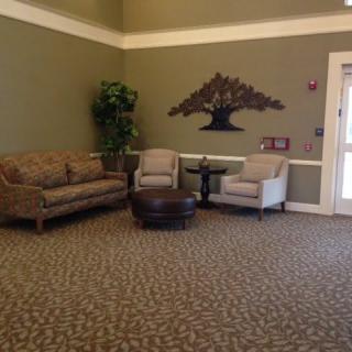 A cozy lobby area with seating and wall decor.