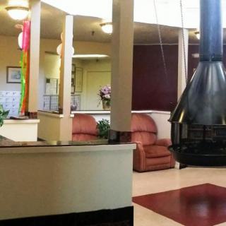A modern lobby with a central fireplace and comfortable seating.
