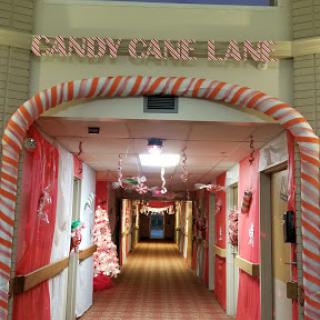 A festive hallway adorned with candy cane decorations, creating a whimsical 'Candy Cane Lane'.