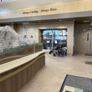 A welcoming lobby area featuring a modern design with wooden accents and a wheelchair accessible space.