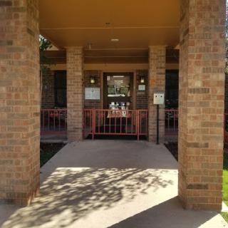 View of a brick building entrance framed by columns.