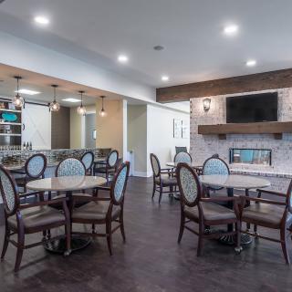 A modern dining room with elegant furniture and a cozy fireplace.
