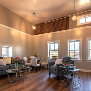A stylish and inviting living room that combines modern decor with ample natural light.