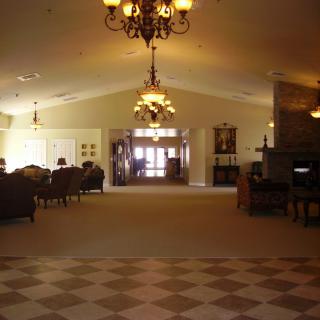 An elegant hotel lobby with chandeliers and comfortable seating.